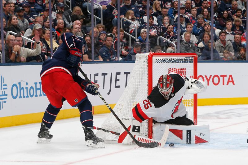 Oct 13, 2025; Columbus, Ohio, USA; New Jersey Devils goalie Jacob Markstrom (25) stops the shot from Columbus Blue Jackets center Sean Monahan (23) during the third period at Nationwide Arena. Mandatory Credit: Russell LaBounty-Imagn Images