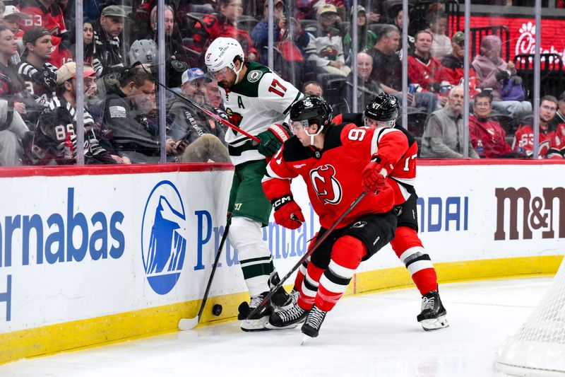 Oct 22, 2025; Newark, New Jersey, USA; New Jersey Devils center Dawson Mercer (91) checks Minnesota Wild left wing Marcus Foligno (17) during the first period at Prudential Center. Mandatory Credit: John Jones-Imagn Images