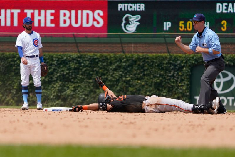 Jun 18, 2023; Chicago, Illinois, USA;Baltimore Orioles designated hitter Anthony Santander (25) is called out at second base by umpire Chris Guccione (68) during the seventh inning at Wrigley Field. Mandatory Credit: David Banks-USA TODAY Sports