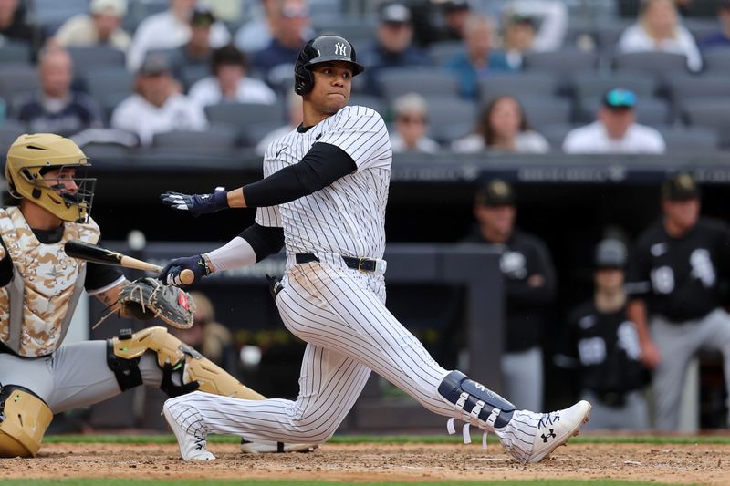 May 18, 2024; Bronx, New York, USA; New York Yankees right fielder Juan Soto (22) follows through on a single during the eighth inning against the Chicago White Sox at Yankee Stadium. Mandatory Credit: Brad Penner-USA TODAY Sports