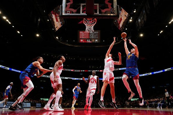 TORONTO, CANADA - DECEMBER 20:  Nikola Jokic #15 of the Denver Nuggets goes to the basket during the game on December 20, 2023 at the Scotiabank Arena in Toronto, Ontario, Canada.  NOTE TO USER: User expressly acknowledges and agrees that, by downloading and or using this Photograph, user is consenting to the terms and conditions of the Getty Images License Agreement.  Mandatory Copyright Notice: Copyright 2023 NBAE (Photo by Mark Blinch/NBAE via Getty Images)