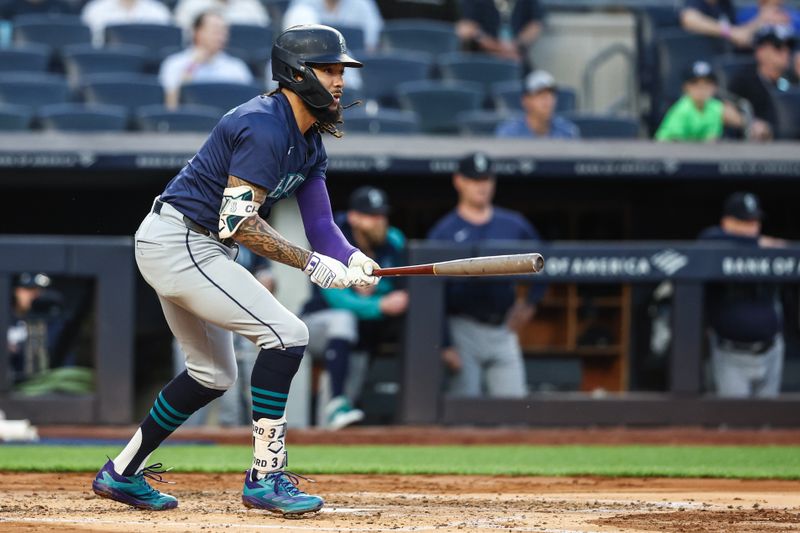 May 22, 2024; Bronx, New York, USA;  Seattle Mariners shortstop J.P. Crawford (3) hits a single in the third inning against the New York Yankees at Yankee Stadium. Mandatory Credit: Wendell Cruz-USA TODAY Sports