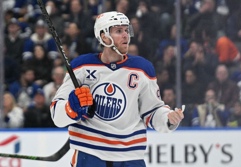 Nov 16, 2024; Toronto, Ontario, CAN;  Edmonton Oilers forward Connor McDavid (97) reacts after being called for a minor penalty against the Toronto Maple Leafs in the second period at Scotiabank Arena. Mandatory Credit: Dan Hamilton-Imagn Images