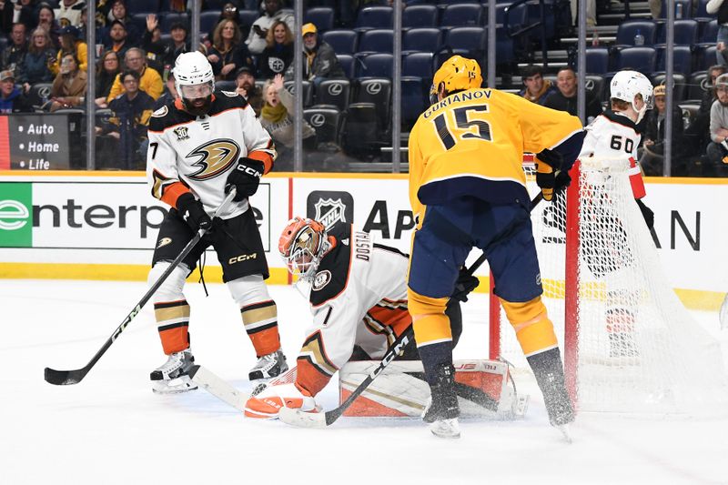 Jan 9, 2024; Nashville, Tennessee, USA; Anaheim Ducks goaltender Lukas Dostal (1) makes a save with pressure from Nashville Predators right wing Denis Gurianov (15) during the third period at Bridgestone Arena. Mandatory Credit: Christopher Hanewinckel-USA TODAY Sports