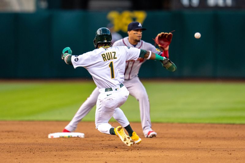 May 30, 2023; Oakland, California, USA;  Atlanta Braves shortstop Orlando Arcia (11) forces out Oakland Athletics center fielder Esteury Ruiz (1) during the fifth inning at Oakland-Alameda County Coliseum. Mandatory Credit: Neville E. Guard-USA TODAY Sports