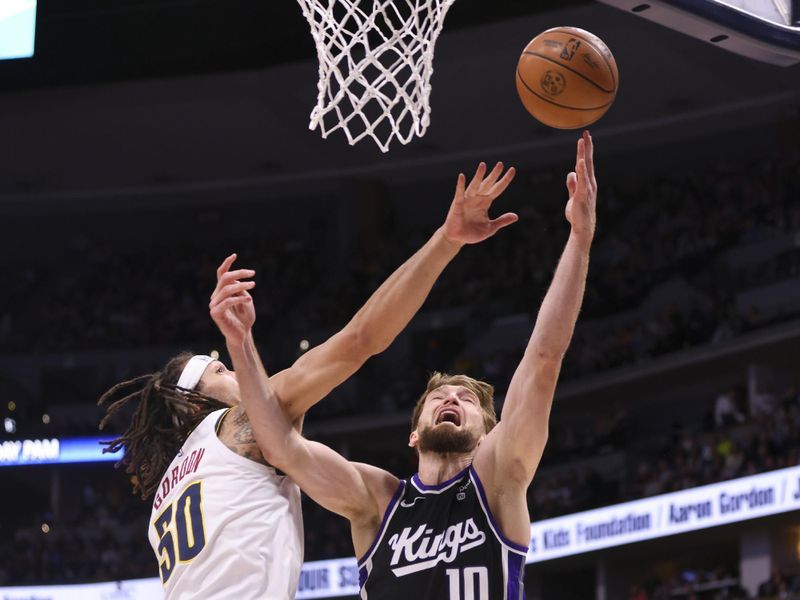 DENVER, COLORADO - FEBRUARY 28: Domantas Sabonis #10 of the Sacramento Kings attempts a layup while Aaron Gordon #50 of the Denver Nuggets defends during the game at Ball Arena on February 28, 2024 in Denver, Colorado. NOTE TO USER: User expressly acknowledges and agrees that, by downloading and or using this photograph, User is consenting to the terms and conditions of the Getty Images License Agreement. (Photo by Alysa Rubin/Clarkson Creative/Getty Images)