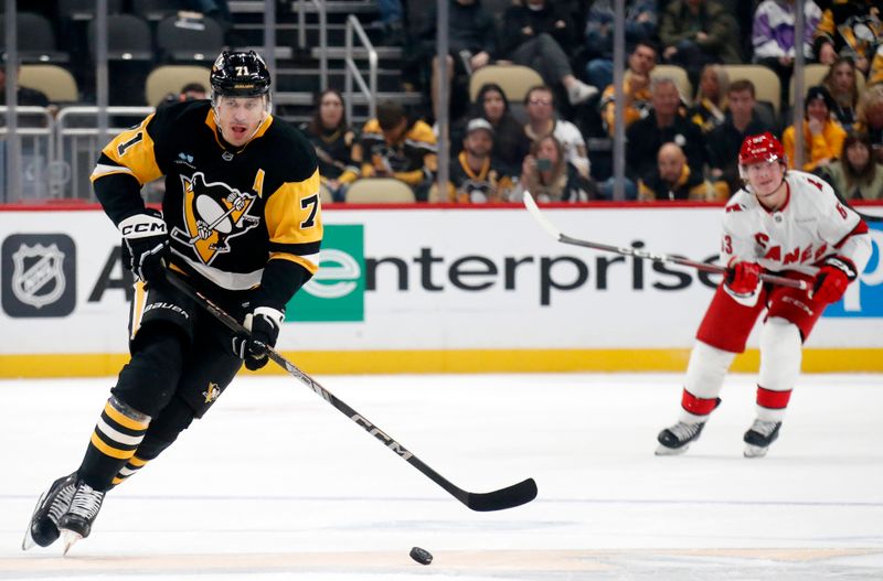 Oct 18, 2024; Pittsburgh, Pennsylvania, USA;  Pittsburgh Penguins center Evgeni Malkin (71) skates up ice with the puck against the Carolina Hurricanes during the third period at PPG Paints Arena. Mandatory Credit: Charles LeClaire-Imagn Images