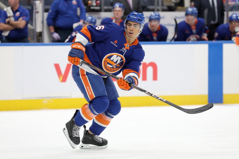 Nov 5, 2024; Elmont, New York, USA; New York Islanders defenseman Isaiah George (36) skates against the Pittsburgh Penguins during the second period at UBS Arena. Mandatory Credit: Brad Penner-Imagn Images