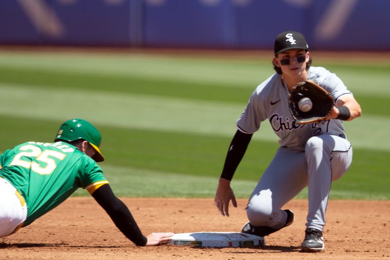 Aug 7, 2024; Oakland, California, USA; Oakland Athletics designated hitter Brent Rooker (25) gets back to second base ahead of the pickoff throw to Chicago White Sox second baseman Brooks Baldwin (27) during the second inning at Oakland-Alameda County Coliseum. Mandatory Credit: D. Ross Cameron-USA TODAY Sports