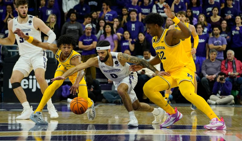 Feb 2, 2023; Evanston, Illinois, USA; Michigan Wolverines forward Tarris Reed Jr. (32) defends Northwestern Wildcats guard Boo Buie (0) during the first half at Welsh-Ryan Arena. Mandatory Credit: David Banks-USA TODAY Sports