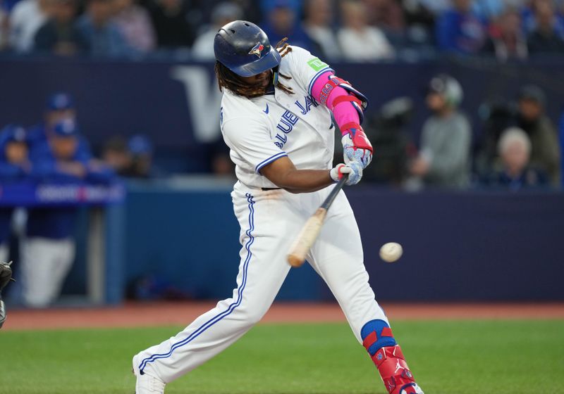 Sep 13, 2023; Toronto, Ontario, CAN; Toronto Blue Jays first baseman Vladimir Guerrero Jr. (27) hits a single against the Texas Rangers during the first inning at Rogers Centre. Mandatory Credit: Nick Turchiaro-USA TODAY Sports