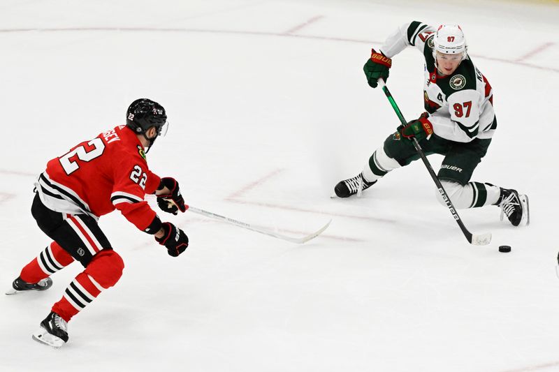 Apr 7, 2024; Chicago, Illinois, USA;  Minnesota Wild left wing Kirill Kaprizov (97) moves the puck away from Chicago Blackhawks defenseman Nikita Zaitsev (22) during the second period at United Center. Mandatory Credit: Matt Marton-USA TODAY Sports