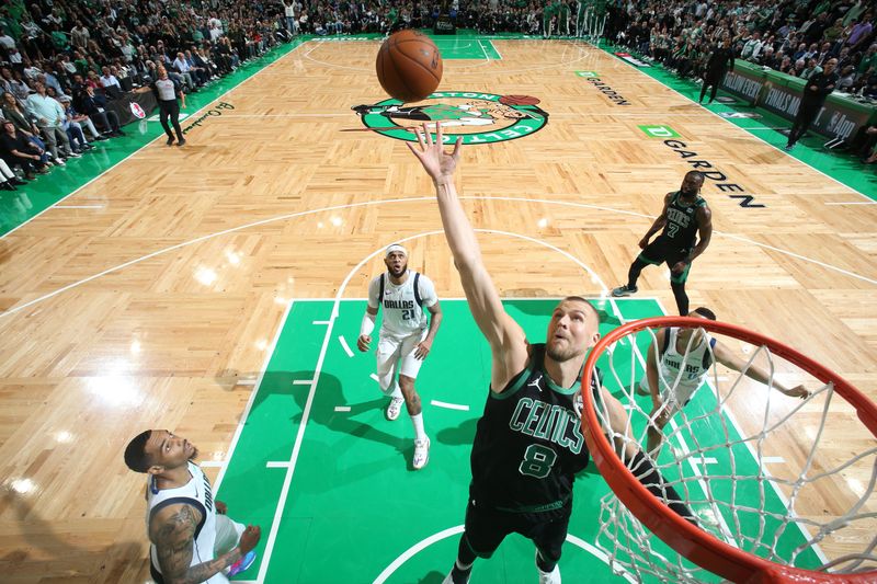BOSTON, MA - JUNE 9: Kristaps Porzingis #8 of the Boston Celtics goes up for the rebound during the game against the Dallas Mavericks during Game 1 of the 2024 NBA Finals on June 9, 2024 at the TD Garden in Boston, Massachusetts. NOTE TO USER: User expressly acknowledges and agrees that, by downloading and or using this photograph, User is consenting to the terms and conditions of the Getty Images License Agreement. Mandatory Copyright Notice: Copyright 2024 NBAE  (Photo by Nathaniel S. Butler/NBAE via Getty Images)