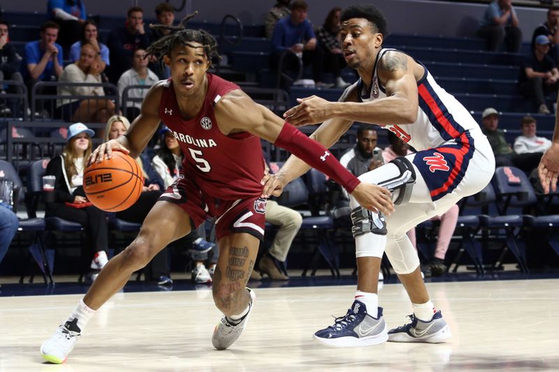 Feb 11, 2023; Oxford, Mississippi, USA; South Carolina Gamecocks guard Meechie Johnson (5) dribbles as Mississippi Rebels forward Robert Allen (21) defends during the first half at The Sandy and John Black Pavilion at Ole Miss. Mandatory Credit: Petre Thomas-USA TODAY Sports