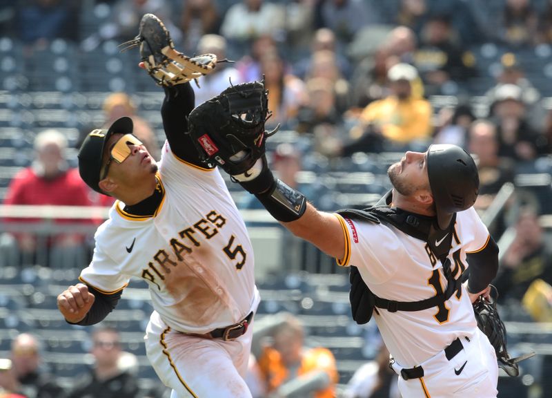 Apr 9, 2025; Pittsburgh, Pennsylvania, USA;  Pittsburgh Pirates first baseman Endy Rodriguez (5) and catcher Joey Bart (14) collide attempting to catch a pop-up hit by St. Louis Cardinals designated hitter Willson Contreras (not pictured) during the eighth inning at PNC Park. Mandatory Credit: Charles LeClaire-Imagn Images