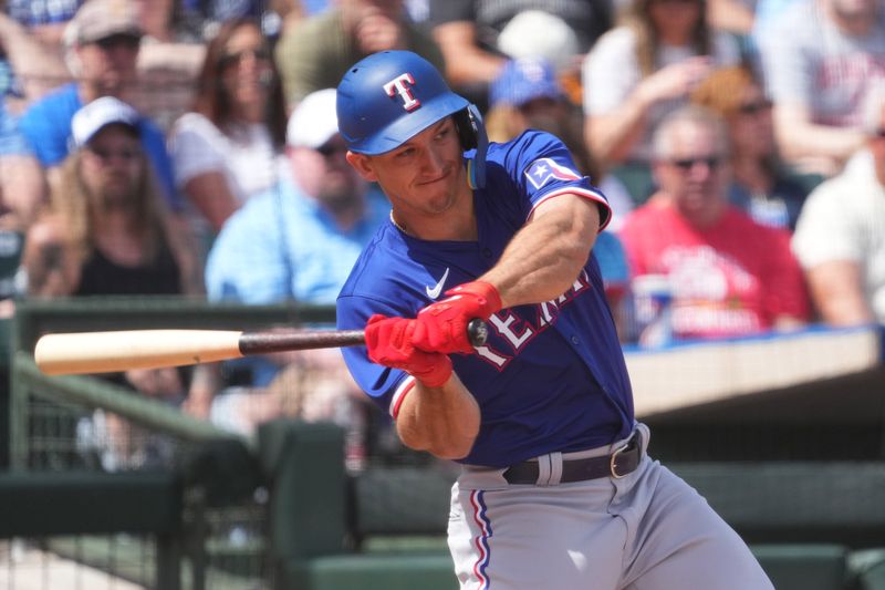 Mar 23, 2024; Surprise, Arizona, USA; Texas Rangers left fielder Wyatt Langford bats against the Kansas City Royals during the third inning at Surprise Stadium. Mandatory Credit: Joe Camporeale-USA TODAY Sports