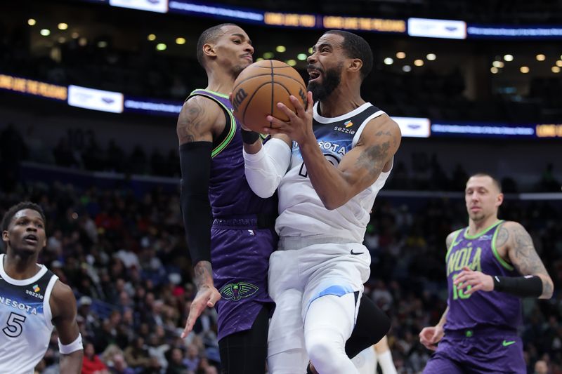 NEW ORLEANS, LOUISIANA - JANUARY 07: Mike Conley #10 of the Minnesota Timberwolves shoots against Dejounte Murray #5 of the New Orleans Pelicans during the second half at the Smoothie King Center on January 07, 2025 in New Orleans, Louisiana. NOTE TO USER: User expressly acknowledges and agrees that, by downloading and or using this Photograph, user is consenting to the terms and conditions of the Getty Images License Agreement. (Photo by Jonathan Bachman/Getty Images)