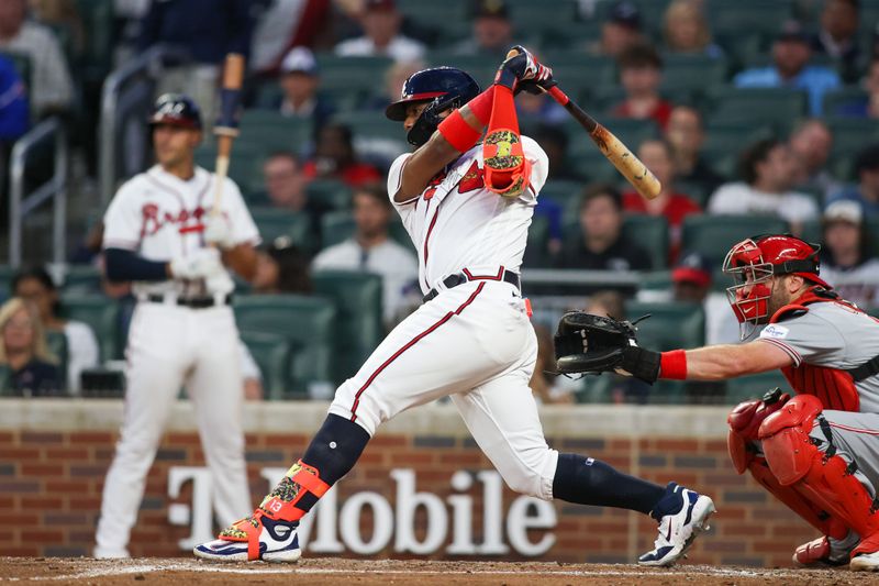 Apr 11, 2023; Atlanta, Georgia, USA; Atlanta Braves right fielder Ronald Acuna Jr. (13) hits an RBI single against the Cincinnati Reds in the third inning at Truist Park. Mandatory Credit: Brett Davis-USA TODAY Sports
