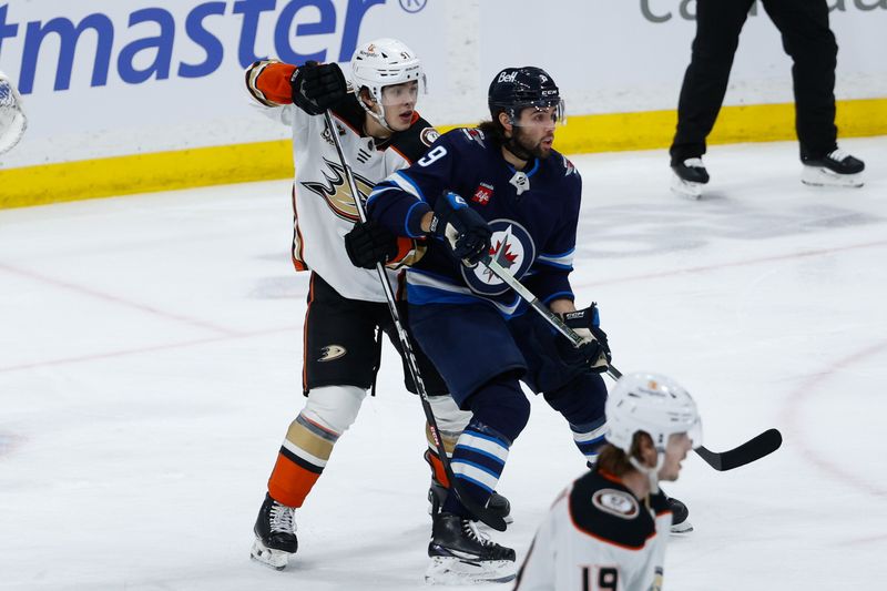 Mar 15, 2024; Winnipeg, Manitoba, CAN; Anaheim Ducks defenseman Olen Zellweger (51) jostles for position with Winnipeg Jets forward Alex Iafallo (9) during the third period at Canada Life Centre. Mandatory Credit: Terrence Lee-USA TODAY Sports