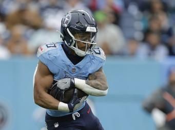 Tennessee Titans running back Tony Pollard (20) runs with the ball during the first half of an NFL football game against the Jacksonville Jaguars, Sunday, Dec. 8, 2024, in Nashville, Tenn. (AP Photo/Stew Milne)