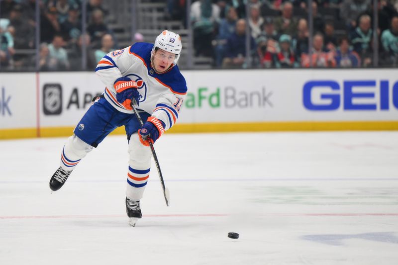 Mar 2, 2024; Seattle, Washington, USA; Edmonton Oilers center Mattias Janmark (13) passes the puck against the Seattle Kraken during the first period at Climate Pledge Arena. Mandatory Credit: Steven Bisig-USA TODAY Sports