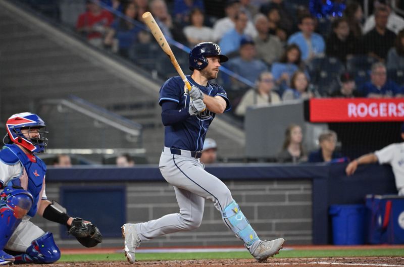 May 14, 2025; Toronto, Ontario, CAN;  Tampa Bay Rays second baseman Brandon Lowe (8) hits a single against the Toronto Blue Jays in the fifth inning at Rogers Centre. Mandatory Credit: Dan Hamilton-Imagn Images