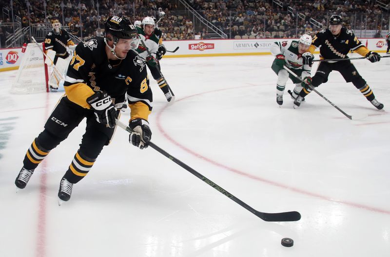 Oct 29, 2024; Pittsburgh, Pennsylvania, USA; Pittsburgh Penguins center Sidney Crosby (87) skates with the puck against the Minnesota Wild during the second period at PPG Paints Arena. Mandatory Credit: Charles LeClaire-Imagn Images