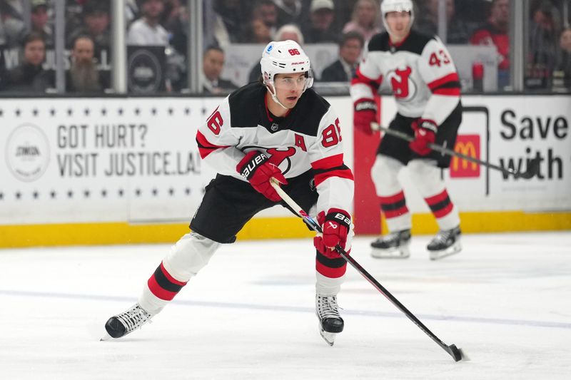 Nov 1, 2025; Los Angeles, California, USA; New Jersey Devils center Jack Hughes (86) skates with the puck against the Los Angeles Kings in the first period at Crypto.com Arena. Mandatory Credit: Kirby Lee-Imagn Images
