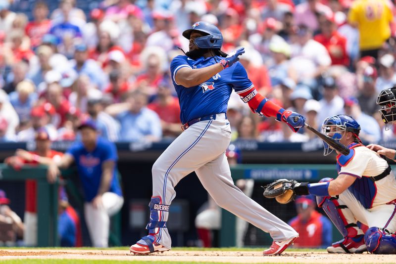 May 8, 2024; Philadelphia, Pennsylvania, USA; Toronto Blue Jays first base Vladimir Guerrero Jr. (27) hits a single during the first inning against the Philadelphia Phillies at Citizens Bank Park. Mandatory Credit: Bill Streicher-USA TODAY Sports