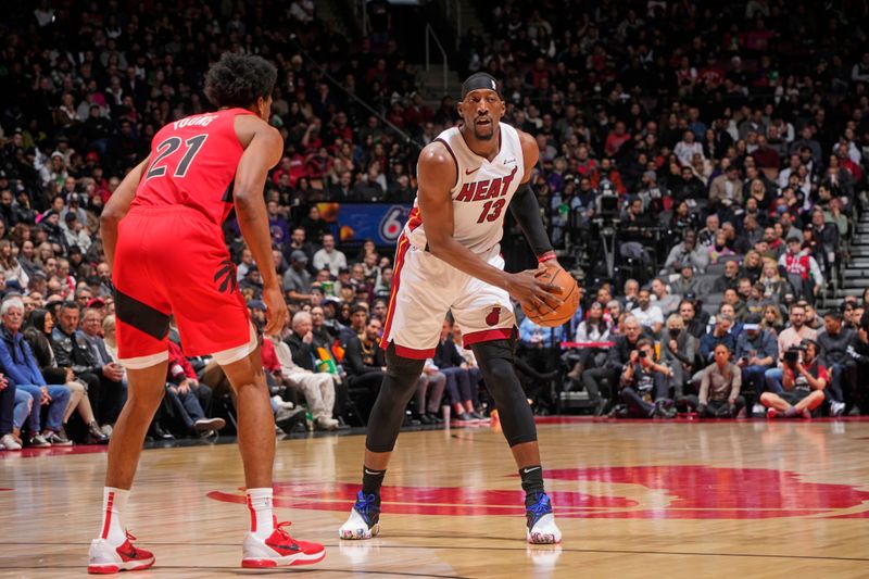 TORONTO, CANADA - JANUARY 17: Bam Adebayo #13 of the Miami Heat looks to pass the ball during the game against the Toronto Raptors on January 17, 2024 at the Scotiabank Arena in Toronto, Ontario, Canada.  NOTE TO USER: User expressly acknowledges and agrees that, by downloading and or using this Photograph, user is consenting to the terms and conditions of the Getty Images License Agreement.  Mandatory Copyright Notice: Copyright 2024 NBAE (Photo by Mark Blinch/NBAE via Getty Images)