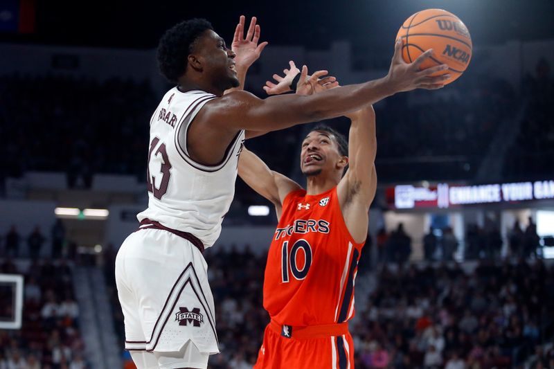 Jan 27, 2024; Starkville, Mississippi, USA; Mississippi State Bulldogs guard Josh Hubbard (13) drives to the basket as Auburn Tigers guard/forward Chad Baker-Mazara (10) defends during the second half at Humphrey Coliseum. Mandatory Credit: Petre Thomas-USA TODAY Sports