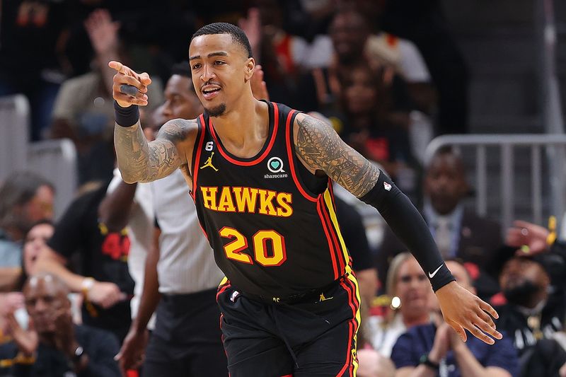 ATLANTA, GEORGIA - APRIL 21:  John Collins #20 of the Atlanta Hawks reacts after hitting a three-point basket against the Boston Celtics during the second quarter of Game Three of the Eastern Conference First Round Playoffs at State Farm Arena on April 21, 2023 in Atlanta, Georgia.  NOTE TO USER: User expressly acknowledges and agrees that, by downloading and or using this photograph, User is consenting to the terms and conditions of the Getty Images License Agreement.  (Photo by Kevin C. Cox/Getty Images)