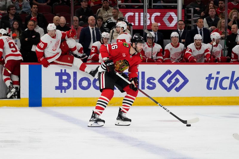 Nov 6, 2024; Chicago, Illinois, USA; Chicago Blackhawks center Jason Dickinson (16) moves the puck against the Chicago Blackhawks during the second period at United Center. Mandatory Credit: David Banks-Imagn Images