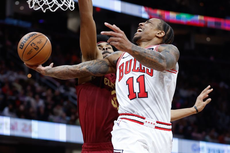 CLEVELAND, OH - FEBRUARY 14: DeMar DeRozan #11 of the Chicago Bulls lays up a shot against Jarrett Allen #31 of the Cleveland Cavaliers during the second half at Rocket Mortgage Fieldhouse on February 14, 2024 in Cleveland, Ohio. NOTE TO USER: User expressly acknowledges and agrees that, by downloading and or using this photograph, User is consenting to the terms and conditions of the Getty Images License Agreement. (Photo by Ron Schwane/Getty Images)