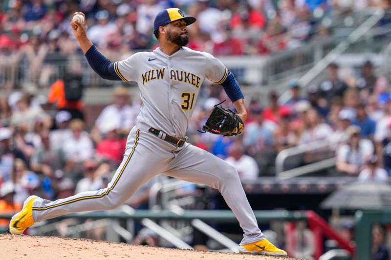 Jul 30, 2023; Cumberland, Georgia, USA; Milwaukee Brewers relief pitcher Joel Payamps (31) pitches against the Atlanta Braves during the eighth inning at Truist Park. Mandatory Credit: Dale Zanine-USA TODAY Sports