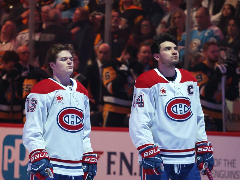 Dec 21, 2025; Pittsburgh, Pennsylvania, USA;  Montréal Canadiens right wing Cole Caufield (13) and center Nick Suzuki (14) stand for the Canadien national anthem against the Pittsburgh Penguins at PPG Paints Arena. Mandatory Credit: Charles LeClaire-Imagn Images