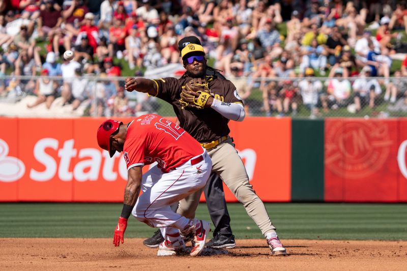 Mar 10, 2024; Tempe, Arizona, USA; San Diego Padres infielder Eguy Rosario (5) makes the throw to first above the slide of Los Angeles Angels outfielder Aaron Hicks (12) in the fourth during a spring training game at Tempe Diablo Stadium. Mandatory Credit: Allan Henry-USA TODAY Sports