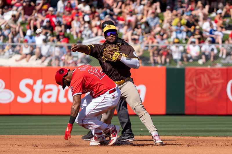Mar 10, 2024; Tempe, Arizona, USA; San Diego Padres infielder Eguy Rosario (5) makes the throw to first above the slide of Los Angeles Angels outfielder Aaron Hicks (12) in the fourth during a spring training game at Tempe Diablo Stadium. Mandatory Credit: Allan Henry-USA TODAY Sports