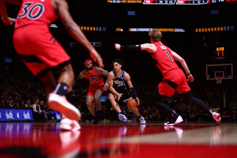 TORONTO, CANADA - MARCH 20: Colby Jones #20 of the Sacramento Kings drives to the basket during the game against the Toronto Raptors on March 20, 2024 at the Scotiabank Arena in Toronto, Ontario, Canada.  NOTE TO USER: User expressly acknowledges and agrees that, by downloading and or using this Photograph, user is consenting to the terms and conditions of the Getty Images License Agreement.  Mandatory Copyright Notice: Copyright 2024 NBAE (Photo by Vaughn Ridley/NBAE via Getty Images)