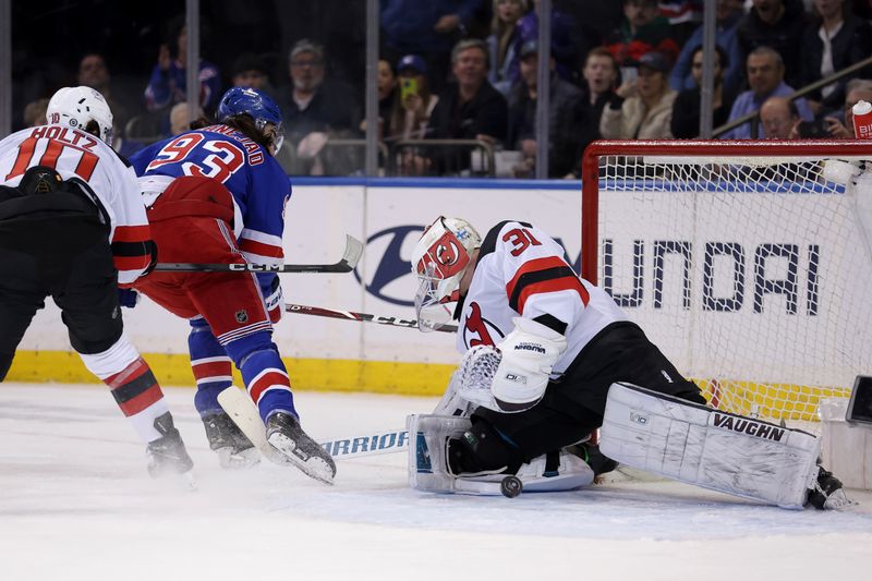 Mar 11, 2024; New York, New York, USA; New Jersey Devils goaltender Kaapo Kahkonen (31) makes a save on a shot by New York Rangers center Mika Zibanejad (93) during the first period at Madison Square Garden. Mandatory Credit: Brad Penner-USA TODAY Sports