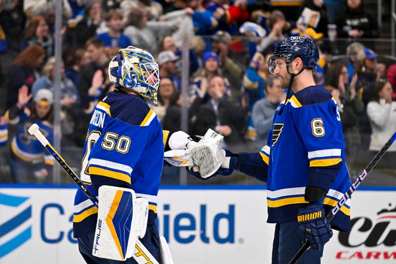 Feb 15, 2024; St. Louis, Missouri, USA;  St. Louis Blues goaltender Jordan Binnington (50) and defenseman Marco Scandella (6) celebrate after the Blues defeated the Edmonton Oilers at Enterprise Center. Mandatory Credit: Jeff Curry-USA TODAY Sports