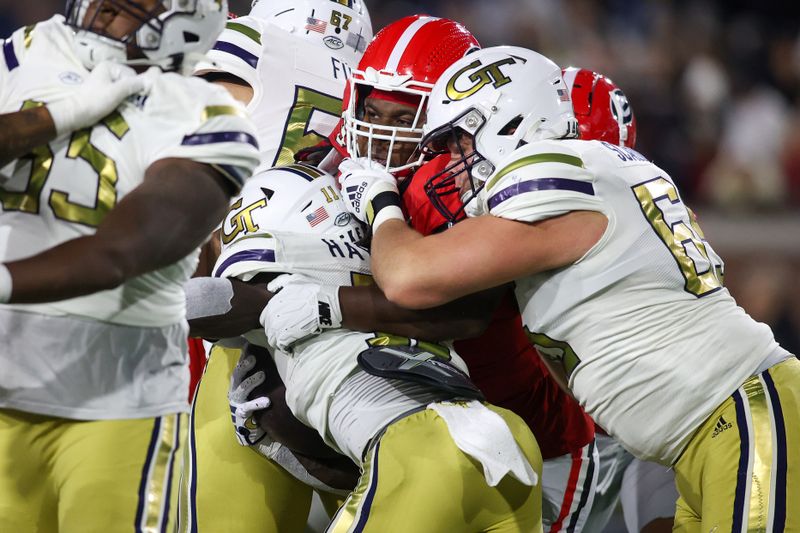 Nov 25, 2023; Atlanta, Georgia, USA; Georgia Bulldogs defensive lineman Warren Brinson (97) tackles Georgia Tech Yellow Jackets running back Jamal Haynes (11) in the second quarter at Bobby Dodd Stadium at Hyundai Field. Mandatory Credit: Brett Davis-USA TODAY Sports
