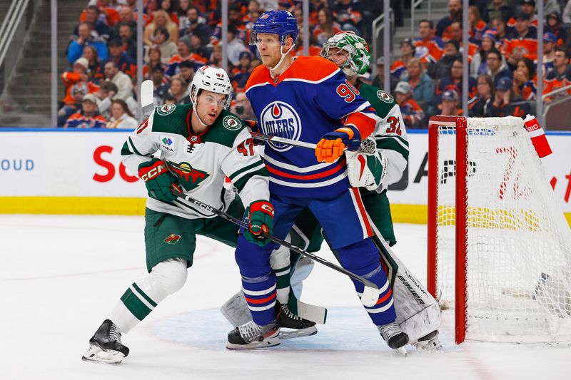 Feb 23, 2024; Edmonton, Alberta, CAN; Edmonton Oilers forward Corey Perry (90) battles with Minnesota Wild defensemen Declan Chisholm (47) in front of goaltender Filip Gustavsson (32) during the first period at Rogers Place. Mandatory Credit: Perry Nelson-USA TODAY Sports