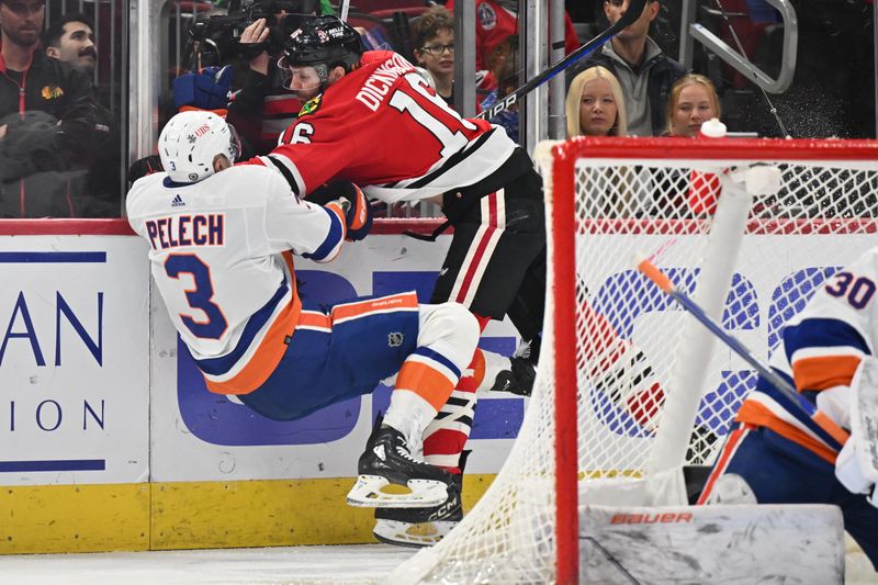 Jan 19, 2024; Chicago, Illinois, USA; Chicago Blackhawks forward Jason Dickinson (16) finishes a check on New York Islanders defenseman Adam Pelech (3) in the first period at United Center. Mandatory Credit: Jamie Sabau-USA TODAY Sports