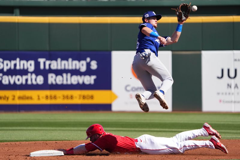 Feb 24, 2025; Goodyear, Arizona, USA; Cincinnati Reds second base Gavin Lux (2) beats a throw to Los Angeles Dodgers infielder Sean McLain (88) during the second inning at Goodyear Ballpark. Mandatory Credit: Joe Camporeale-Imagn Images