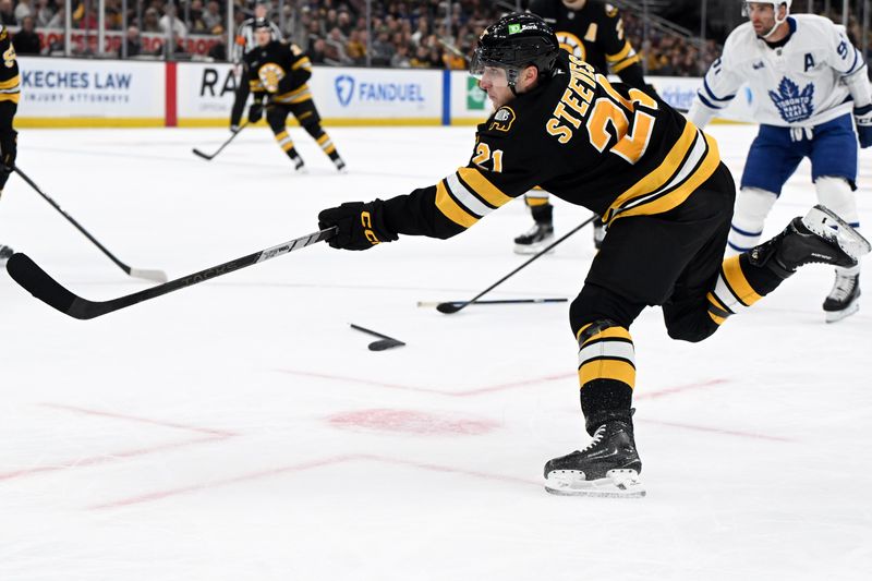 Nov 11, 2025; Boston, Massachusetts, USA; Boston Bruins center Alex Steeves (21) takes a shot against the Toronto Maple Leafs during the first period at the TD Garden. Mandatory Credit: Brian Fluharty-Imagn Images
