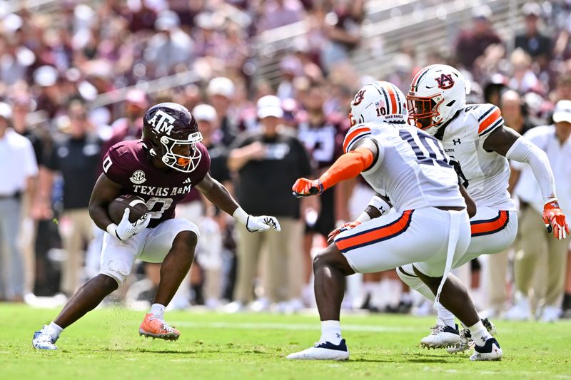 Sep 23, 2023; College Station, Texas, USA; Texas A&M Aggies wide receiver Ainias Smith (0) runs the ball during the third quarter against the Auburn Tigers at Kyle Field. Mandatory Credit: Maria Lysaker-USA TODAY Sports