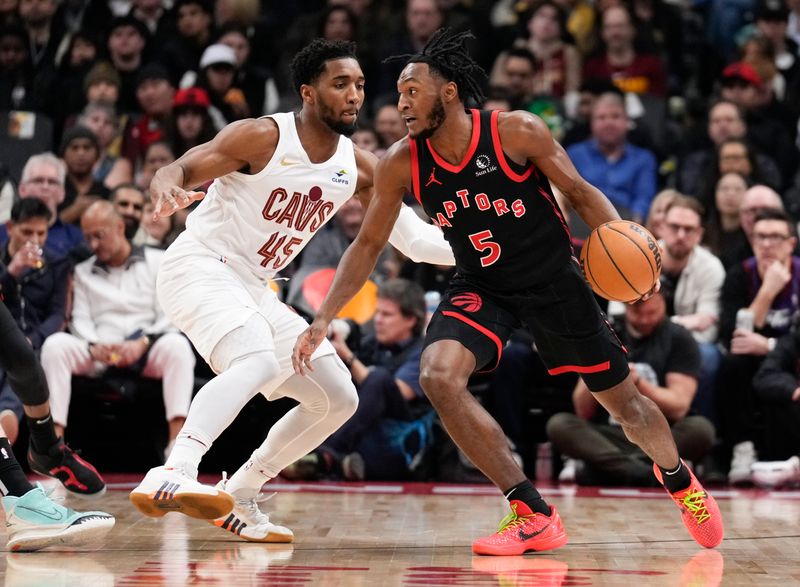 TORONTO, ON - FEBRUARY 10: Immanuel Quickley #5 of the Toronto Raptors is guarded by Donovan Mitchell #45 of the Cleveland Cavaliers during the first half of their basketball game at the Scotiabank Arena on February 10, 2024 in Toronto, Ontario, Canada. NOTE TO USER: User expressly acknowledges and agrees that, by downloading and/or using this Photograph, user is consenting to the terms and conditions of the Getty Images License Agreement. (Photo by Mark Blinch/Getty Images)