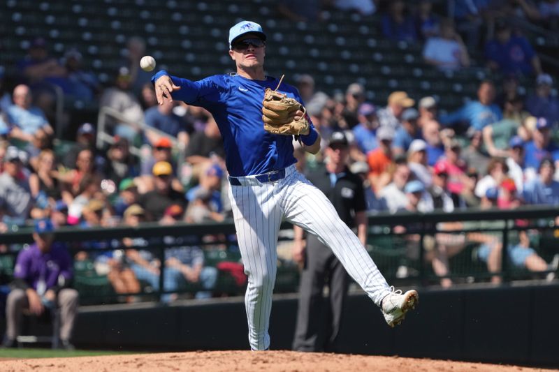 Mar 4, 2025; Mesa, Arizona, USA; Chicago Cubs third baseman Matt Shaw makes the off balance throw for an out against the San Diego Padres in the second inning at Sloan Park. Mandatory Credit: Rick Scuteri-Imagn Images