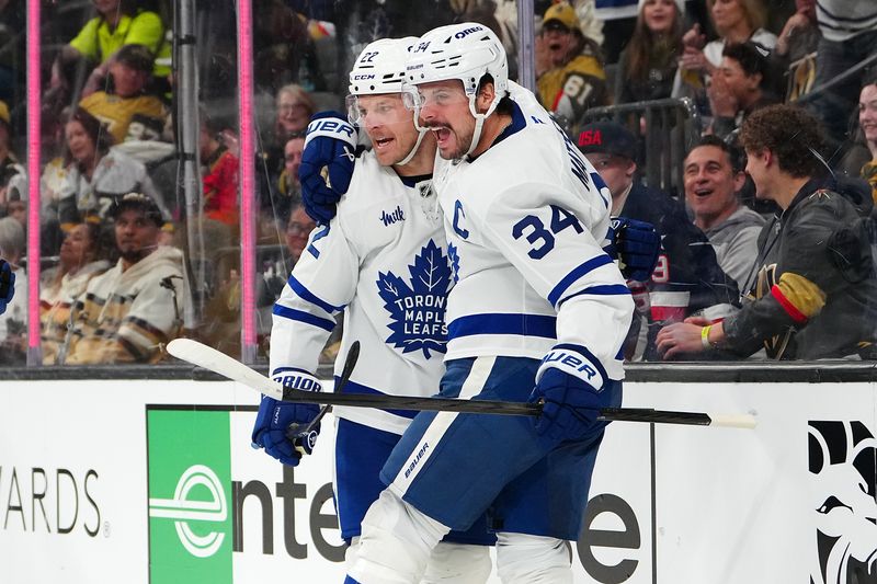 Jan 15, 2026; Las Vegas, Nevada, USA; Toronto Maple Leafs center Auston Matthews (34) celebrates with Toronto Maple Leafs defenseman Jake McCabe (22) after scoring a goal against the Vegas Golden Knights during the first period at T-Mobile Arena. Mandatory Credit: Stephen R. Sylvanie-Imagn Images